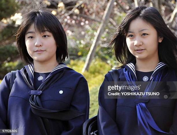 Japanese Emperor's second son Prince Akishino's daughrers Princess Mako and Princess Kako smile as Mako graduates from Gakushuin girls' high school...