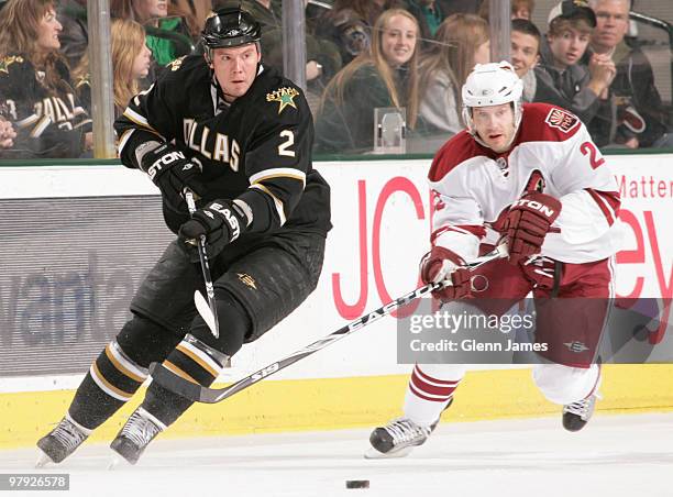 Nicklas Grossman of the Dallas Stars handles the puck against Lee Stempniak of the Phoenix Coyotes on March 21, 2010 at the American Airlines Center...