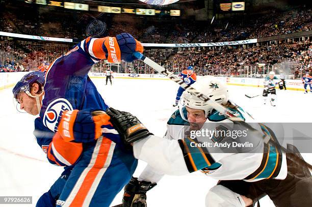 Douglas Murray of the San Jose Sharks fights for the puck with Sam Gagner of the Edmonton Oilers at Rexall Place on March 21, 2010 in Edmonton,...