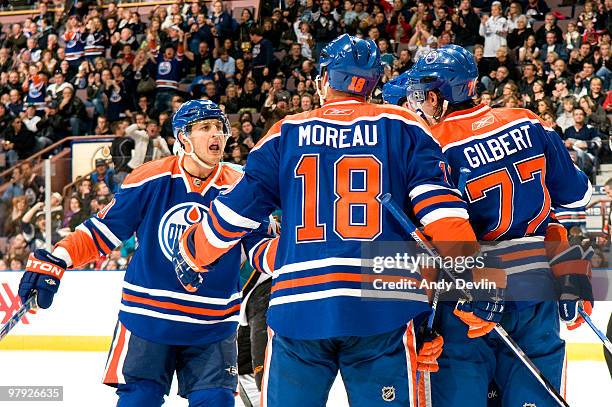 Shawn Horcoff, Ethan Moreau and Tom Gilbert of the Edmonton Oilers celebrate a second period goal against the San Jose Sharks at Rexall Place on...