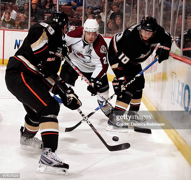 Matt Beleskey and Corey Perry of the Anaheim Ducks defends against Paul Stastny of the Colorado Avalanche during the game on March 21, 2010 at Honda...