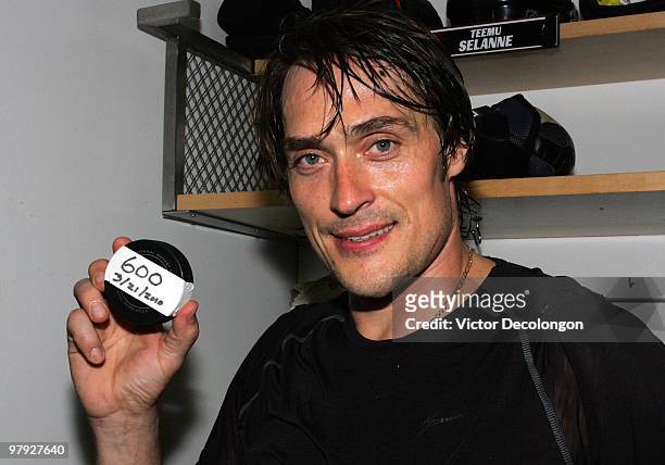 Teemu Selanne of the Anaheim Ducks holds up the puck with which he scored his 600th career NHL goal against the Colorado Avalanche after their NHL...