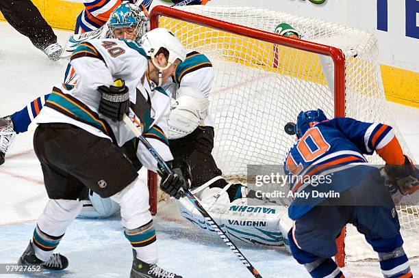 Shawn Horcoff of the Edmonton Oilers puts the puck past Evgeni Nabokov of the San Jose Sharks at Rexall Place on March 21, 2010 in Edmonton, Alberta,...