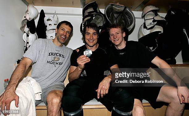 Teemu Selanne of the Anaheim Ducks poses with the puck and teammates who assisted his 600th career goal, Scott Niedermayer had his 200th assist and...