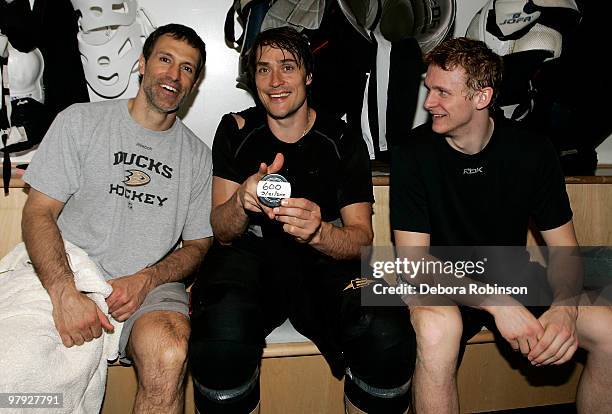 Teemu Selanne of the Anaheim Ducks poses with the puck and teammates who assisted his 600th career goal, Scott Niedermayer had is 200th assist and...