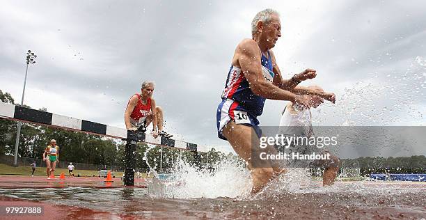 Athletes compete in the 2000M steeplechase final at the Athletics warm up track during the Sydney 2009 World Masters Games at Sydney Olympic Park...