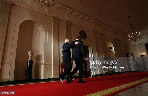 President Barack Obama and Vice President Joe Biden put their arms around each other after Obama spoke from the East Room of the White House after...