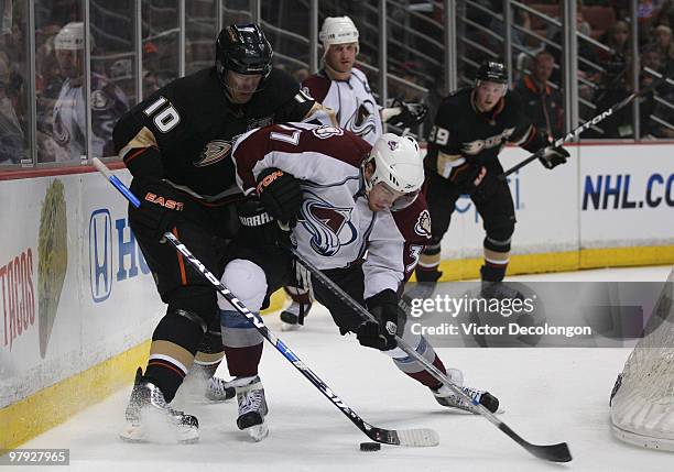 Ryan O'Reilly of the Colorado Avalanche protects the puck from Corey Perry of the Anaheim Ducks during their NHL game at the Honda Center on March...