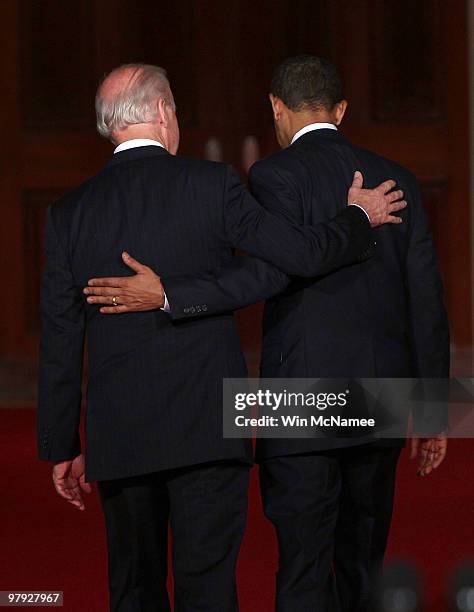 President Barack Obama and Vice President Joseph Biden put their arms around each other after Obama spoke from the East Room of the White House after...