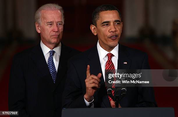 President Barack Obama , with Vice President Joseph Biden , speaks from the East Room of the White House after passage of his health care reform...