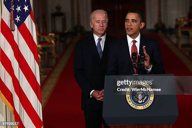 President Barack Obama , with Vice President Joseph Biden , speaks from the East Room of the White House after passage of Obama's health care reform...