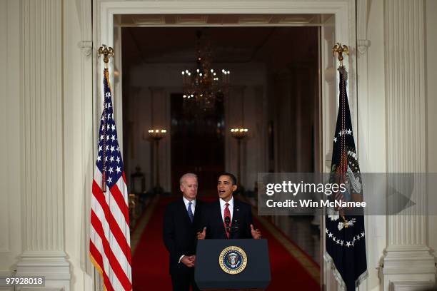 President Barack Obama , with Vice President Joseph Biden , speaks from the East Room of the White House after passage of Obama's health care reform...