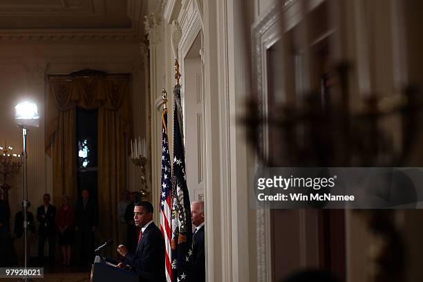 President Barack Obama , with Vice President Joseph Biden , speaks from the East Room of the White House after passage of Obama's health care reform...