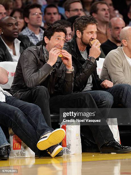 Gerard Butler and Adrien Brody attend a game between the Washington Wizards and the Los Angeles Lakers at Staples Center on March 21, 2010 in Los...