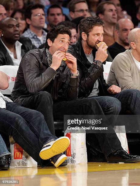 Gerard Butler and Adrien Brody attend a game between the Washington Wizards and the Los Angeles Lakers at Staples Center on March 21, 2010 in Los...