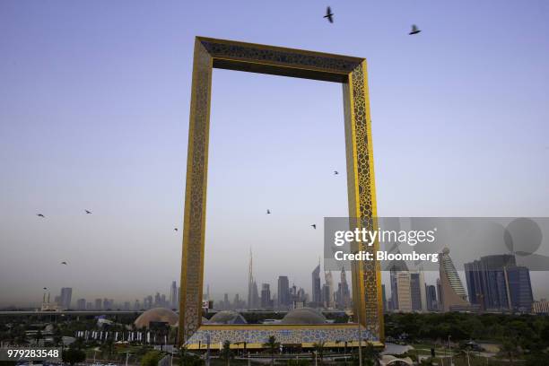 The Burj Khalifa skyscraper, center left, stands above the city skyline seen through the Dubai Frame architectural landmark in Dubai, United Arab...