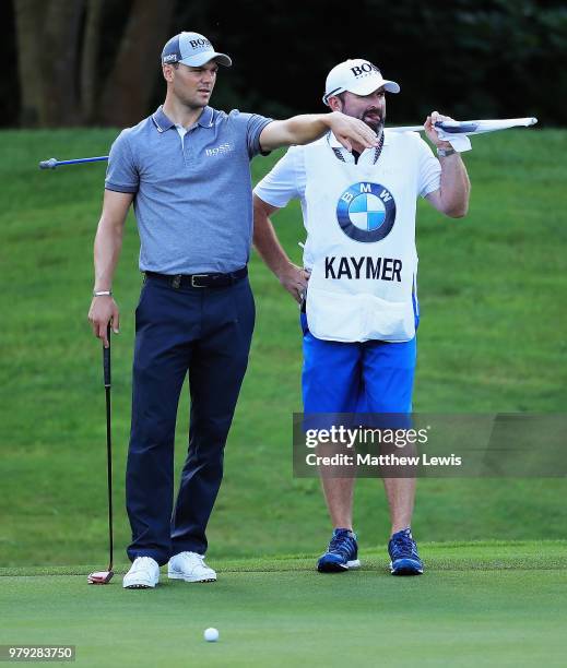 Martin Kaymer of Germany looks on with his caddie Craig Connelly during a practice round ahead of the BMW International Open at Golf Club Gut...