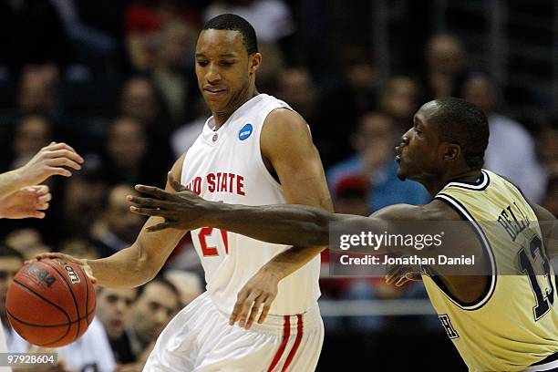 Evan Turner of the Ohio State Buckeyes moves the ball as he is covered by D'Andre Bell of the Georgia Tech Yellow Jackets in the first half during...