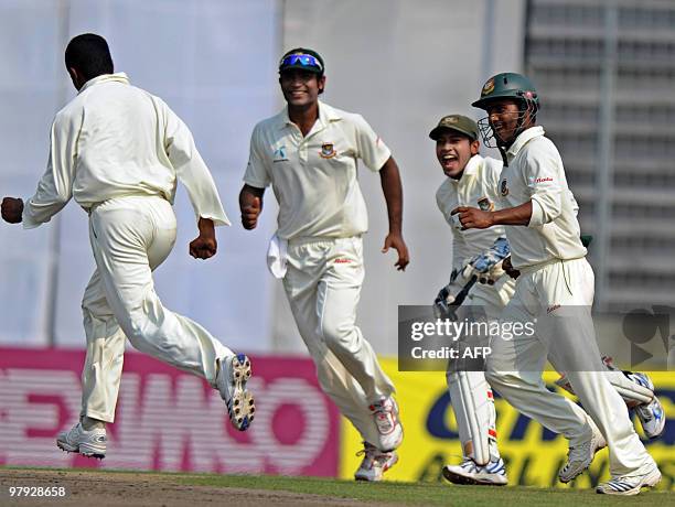 Bangladeshi cricketers Junaid Siddique , Mushfiqur Rahim and Imrul Kayes celebrate with captain Shakib Al Hasan after the dismissal of England...