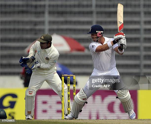 England cricketer Matt Prior plays a shot as Bangladeshi crcketer Mushfiqur Rahim looks on during the third day of the second test match between...