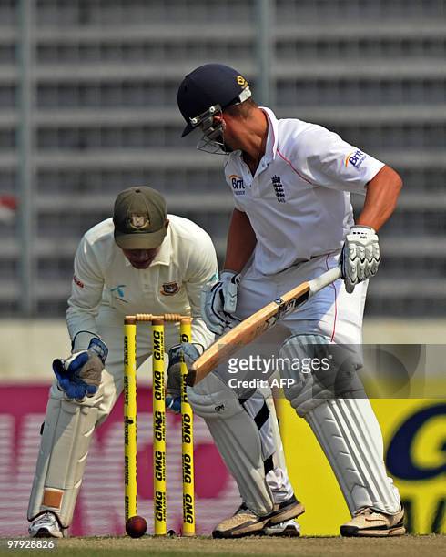 England cricketer Jonathan Trott and Bangladeshi cricketer Mushfiqur Rahim watch the ball about to hit the stump during the third day of the second...