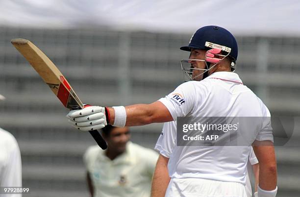 England cricketer Matt Prior raises his bat after scoring a half century during the third day of the second test match between Bangladesh and England...