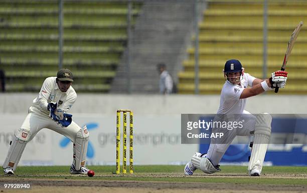 England cricketer Matt Prior plays a shot as the Bangladeshi crcketer Mushfiqur Rahim looks on during the third day of the second test match between...