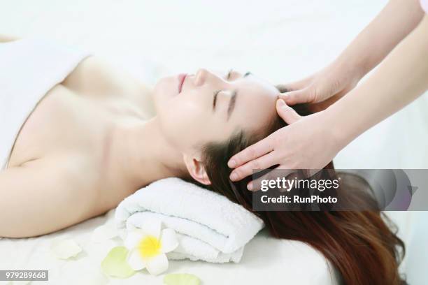 woman getting head massage - body massage japan stock pictures, royalty-free photos & images