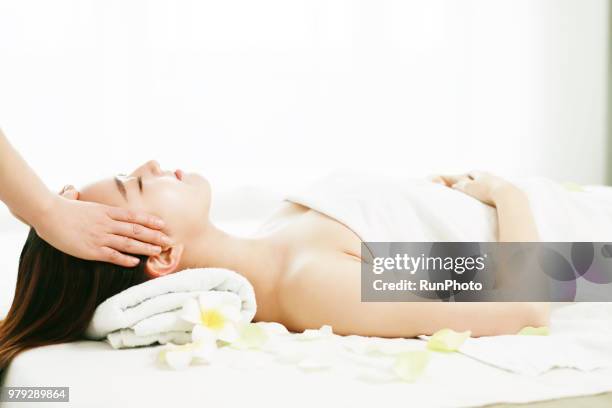 woman enjoying head and face massage - body massage japan stock pictures, royalty-free photos & images