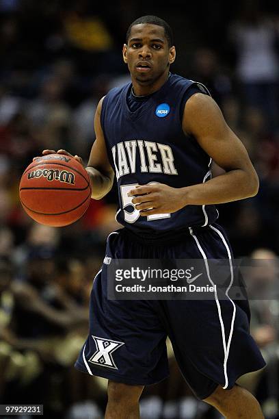 Terrell Holloway of the Xavier Musketeers moves the ball against against the Pittsburgh Panthers in the second half during the second round of the...