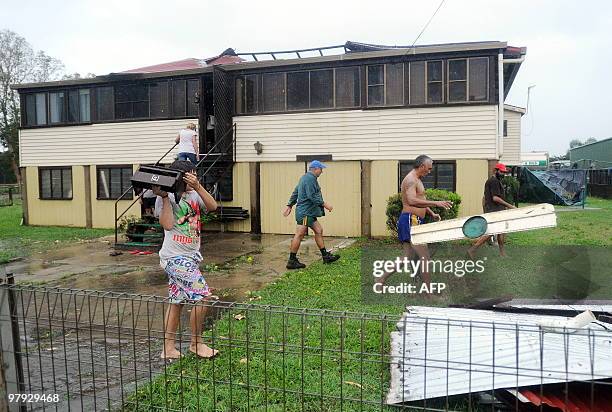 The Van Der Wolf family in Proserpine start to move out and clear debris after their house was unroofed during Cyclone Ului along the Queensland...