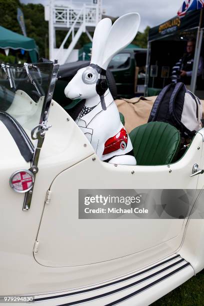 Model Hare in passenger seat of Wolseley Sports car at Brooklands Racing Circuit on June 16, 2018 in Weybridge, England.