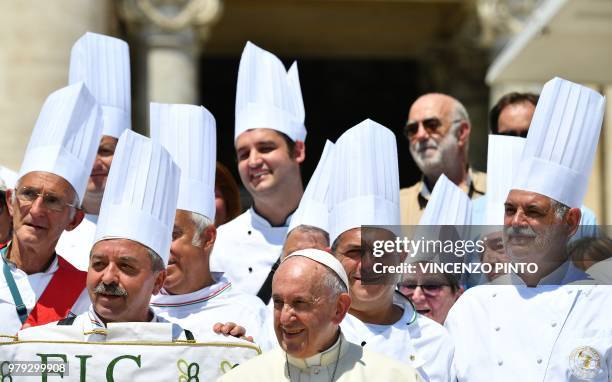 Pope Francis poses with Italian chefs in St Peters square at the Vatican at the end of his weekly general audience on June 20, 2018.