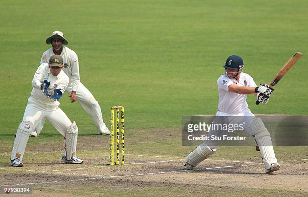 England batsman Ian Bell hits a ball to the boundary watched by wicketkeeper Mushfiqur Rahim during day three of the 2nd Test match between...
