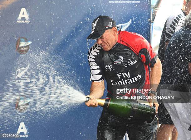 Team New Zealand's Grant Dalton sprays champagne as he celebrates following the finals of the Louis Vuitton sailing trophy in Auckland on March 21,...