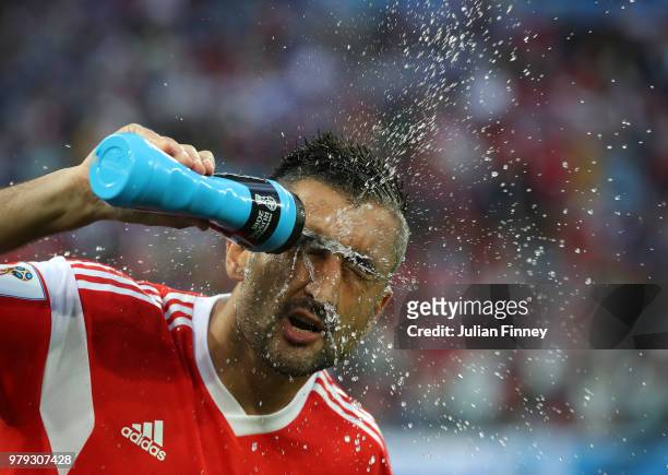 Alexandr Samedov of Russia sprays water over his face before the 2018 FIFA World Cup Russia group A match between Russia and Egypt at Saint...
