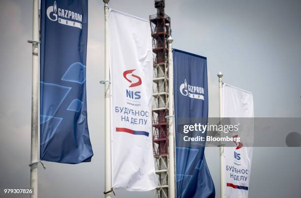 Company banners fly near a cracking tower at the Naftna Industrija Srbija AD oil refinery, operated by OAO Gazprom Neft PJSC, in Pancevo, Serbia, on...