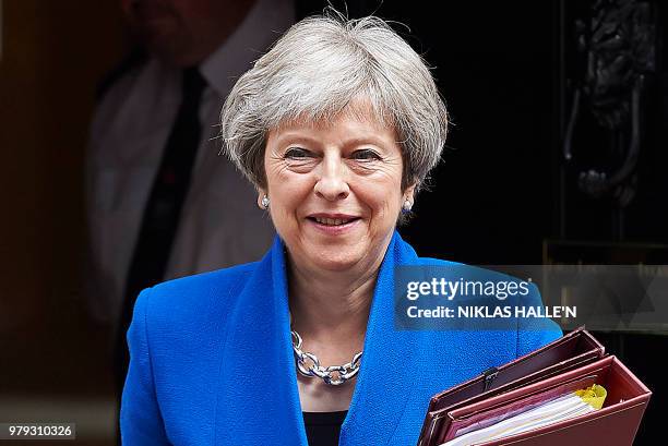 Britain's Prime Minister Theresa May leaves 10 Downing Street in central London on June 20 as she heads to the weekly Prime Minister's Questions...
