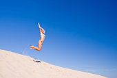 female exercising on a sand dune
