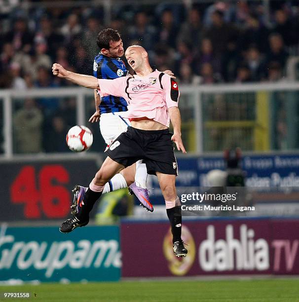 Giulio Migliaccio of US Citta' di Palermo battles for the ball with Dejan Stankovic of FC Internazionale Milano during the Serie A match between US...