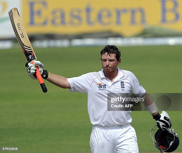 England cricketer Ian Bell raises his bat on scoring a century during the third day of the second Test match between Bangladesh and England at the...