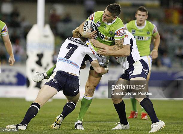 Joel Thompson of the Raiders is tackled by Peter Wallace of the Broncos during the round two NRL match between the Canberra Raiders and the Brisbane...