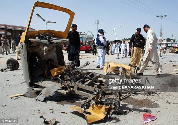 Pakistani security officials examine the wreckage of an auto-rickshaw following a bomb blast in Quetta on March 22, 2010. A bomb planted under a...