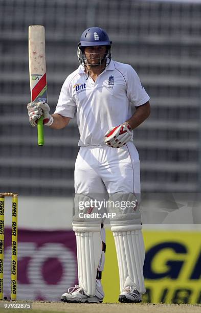 England cricketer Tim Bresnan raises his bat after scoring a half century during the third day of the second Test match between Bangladesh and...