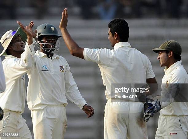 Bangladeshi cricket captain Shakib Al Hasan celebrates with teammates Mohammad Mahmudullah , Mushfiqur Rahim and Jahurul Islam after the dismissal of...