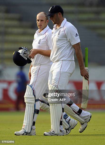 England cricketers Tim Bresnan and James Tredwell leave the field after the third day of the second Test match between Bangladesh and England at the...