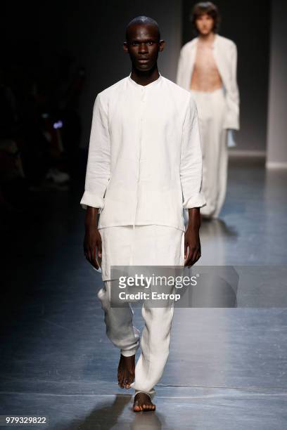 Model walks the runway at the Sartorial Monk show during Milan Men's Fashion Week Spring/Summer 2019 on June 18, 2018 in Milan, Italy.