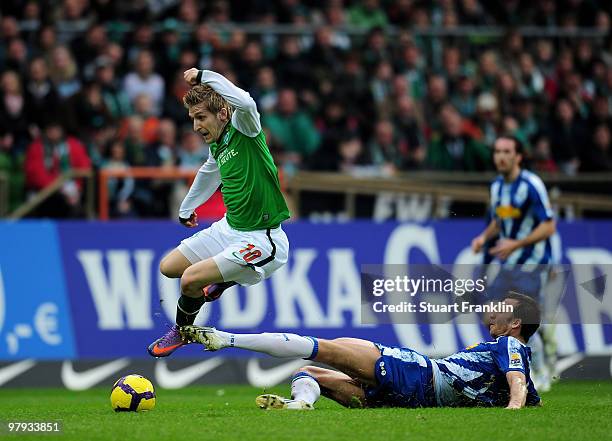 Marko Marin of Bremen is challenged by Christoph Dabrowski of Bochum during the Bundesliga match between SV Werder Bremen and VfL Bochum at Weser...