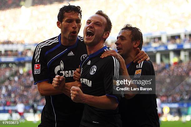 Ivan Rakitic of Schalke celebrates with team mates Rafinha and Kevin Kuranyi after scoring his teams second goal during the Bundesliga match between...