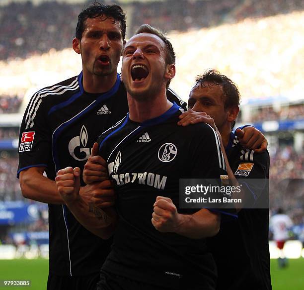 Ivan Rakitic of Schalke celebrates with team mates Rafinha and Kevin Kuranyi after scoring his teams second goal during the Bundesliga match between...